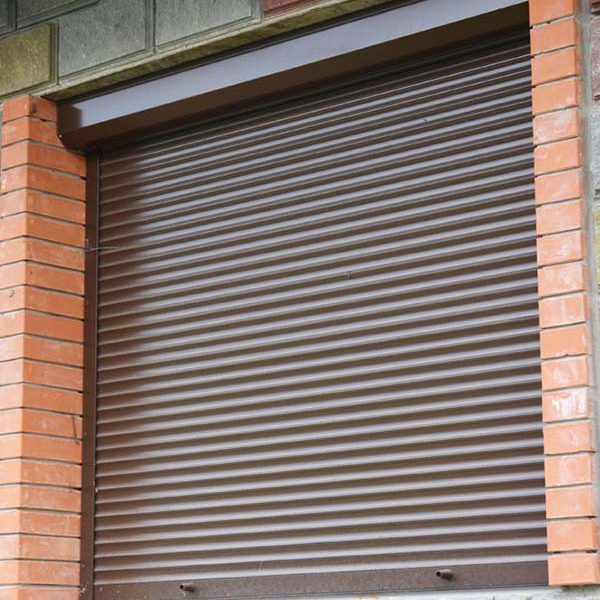Window with rolling shutter for house protection. Security Shutters Grilles. Shutter security barrier.